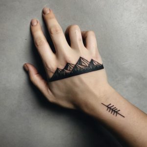 Leonardo_Kino_XL_A_minimalist_mountain_range_tattoo_for_the_ha_2