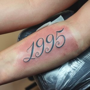 birth year arm tattoo