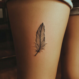 women’s feather tattoo on arm