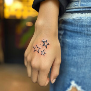 3 stars and a sun tattoo