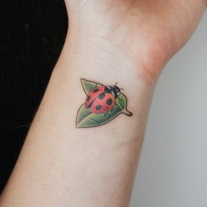 flower ladybug tattoo