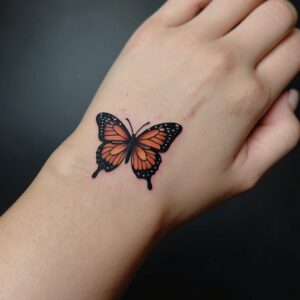 small butterfly hand tattoo