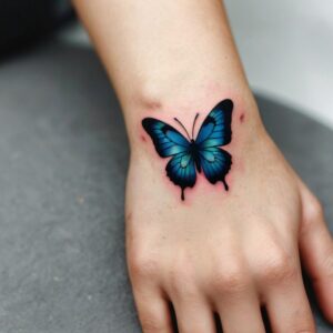 small butterfly tattoo on hand for girl with meaning