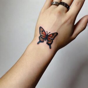 small butterfly tattoo on wrist