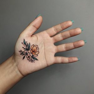 small flower hand tattoo