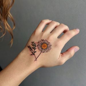 small flower hand tattoo female